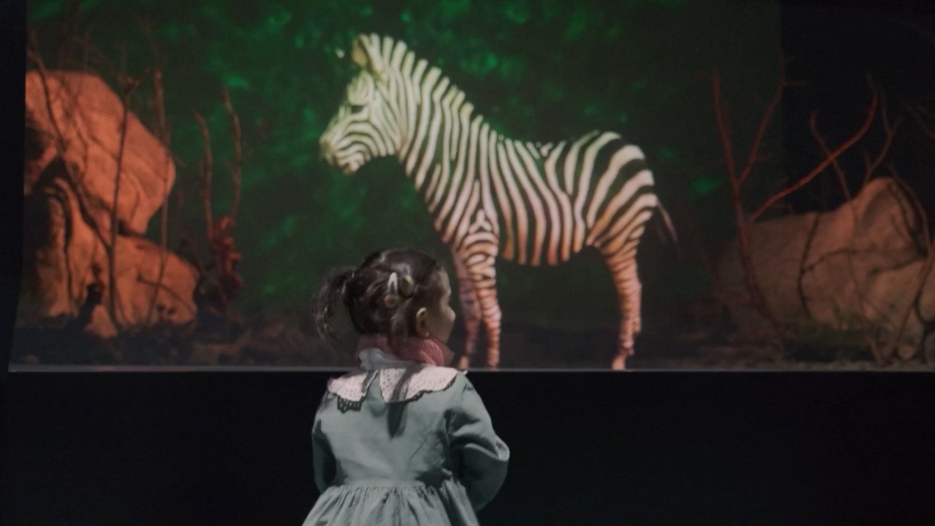 Child encountering a life-size holographic zebra